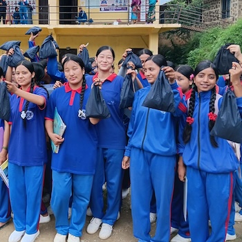SAG Kit Distribution image showing Nepal Madhyamik School girls receiving 250 kits in Rolpa, Nepal on July 31, 2026