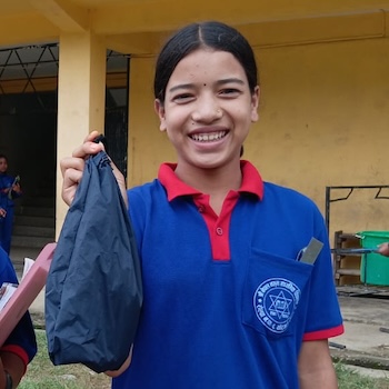 SAG Kit Distribution image showing Nepal Madhyamik School girls receiving 250 kits in Rolpa, Nepal on July 31, 2026
